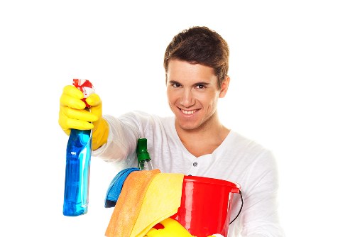 Cleaner preparing a tidy, fresh living space for SW17 customers
